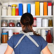 Woman in front of a cluttered pantry