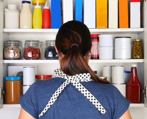 Woman in front of a cluttered pantry