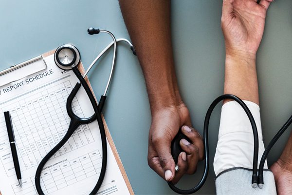 Image showing a doctor reading a patient's blood pressure