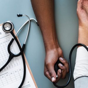 Image of a doctor reading someone's blood pressure