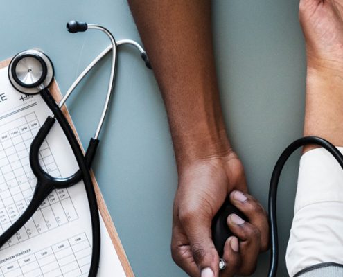 Image of a doctor reading someone's blood pressure