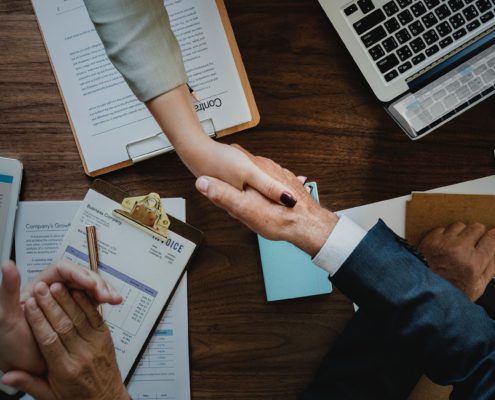 Image of people shaking hands after a completed transaction