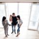 Image of a family and their Realtor during an open house.