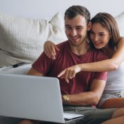 Image of a couple searching for homes online.