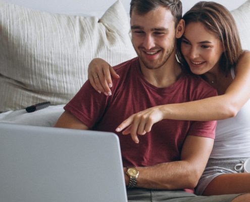 Image of a couple searching for homes online.